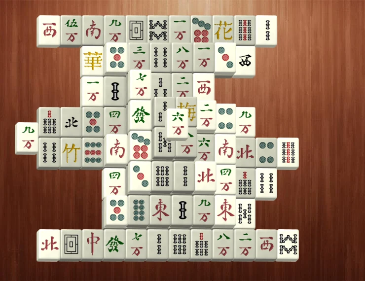Layered Mahjong Solitaire tiles on a wooden table